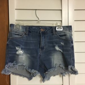 Dark blue denim with holes on pockets